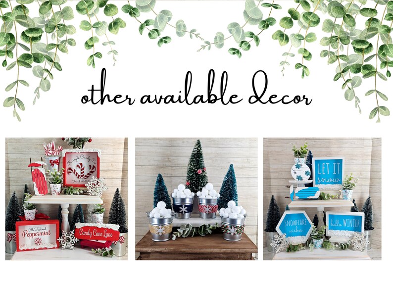 May include: Three tiered trays decorated with winter-themed decor. The top tray features a red and white candy cane sign, a red and white striped candy cane, a white snowflake, and a small potted plant. The middle tray features a white vase with a green plant, a blue and white striped bucket with white balls, and a blue and white striped bucket with white balls. The bottom tray features a red and white sign that says "Candy Cane Lane", a red and white sign that says "Peppermint", and a small potted plant.