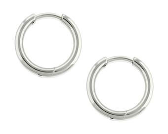 May include: A pair of polished silver-toned hoop earrings featuring a circular design with a smooth, reflective metallic finish and a hinged closure mechanism. These earrings are simple, round, and have a consistent thickness throughout the entire hoop.