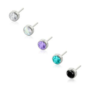 May include: A set of five stud earrings featuring round, faceted gemstones in clear, iridescent, purple, turquoise, and black colors. Each earring is set in a polished silver-tone metal bezel with a straight post extending from the back.