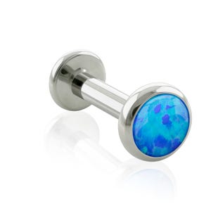 May include: A silver-toned metal labret stud featuring a flat circular back and a front end set with a round, vibrant blue synthetic opal cabochon. The polished metal post connects the two ends, creating a sleek piece of body jewelry.