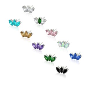 May include: Set of ten pairs of earrings featuring a cluster of three marquise-shaped crystals. The earrings are available in a variety of colors, including clear, turquoise, green, pink, purple, iridescent, blue, and black.