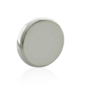 May include: A circular, polished silver-toned metal disc with a smooth, reflective surface. The object features a slightly bevelled edge that catches the light, creating a subtle gradient effect across its metallic, rounded face.