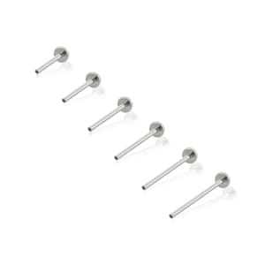May include: Six silver-toned metal labret studs, each featuring a flat circular disc base and a straight post. These body jewelry pieces are arranged in a diagonal line, showcasing a smooth, polished finish and a simple, functional design.