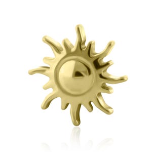 May include: A gold-colored sun-shaped charm with radiating rays. The charm has a smooth, polished surface and a central circular design. This jewelry piece is suitable for necklaces, bracelets, or earrings.