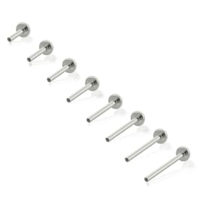 May include: A collection of eight silver-toned metal labret studs arranged in a diagonal line. Each piece features a flat circular disc base attached to a smooth, straight post with a threaded end, designed for body piercing applications.