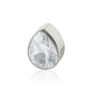 May include: A teardrop-shaped stud earring featuring a clear, faceted gemstone set within a smooth, polished silver-toned metal frame. The design showcases a pointed top and a rounded base, reflecting light through the transparent stone surface.