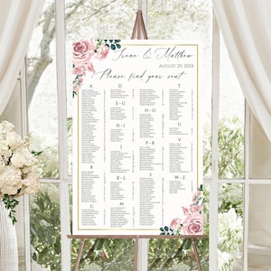 May include: A wedding seating chart with a floral design. The chart is on an easel and has the names "Free & Matthew" and the date "August 29, 202x". The chart lists guests' names alphabetically by last name.