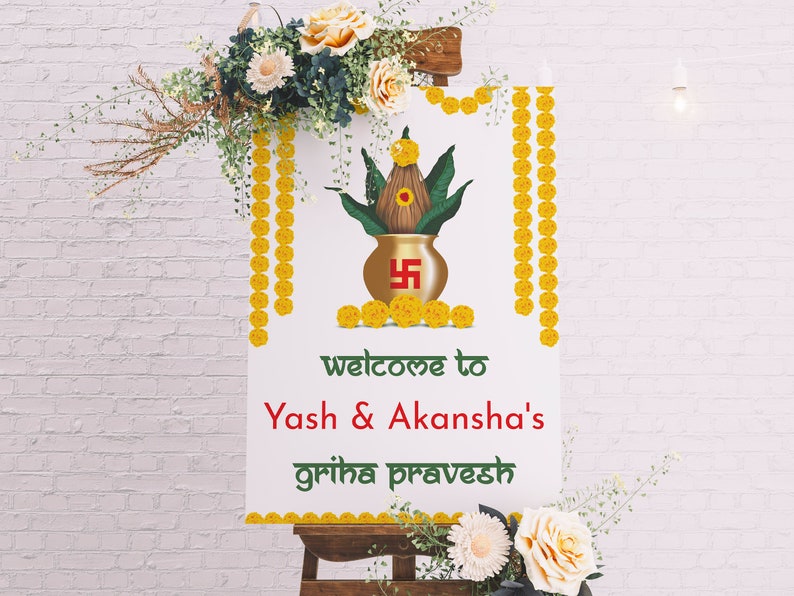 May include: A white sign with a gold pot and green leaves, decorated with yellow flowers. The sign reads "Welcome to Yash & Akansha's Griha Pravesh".