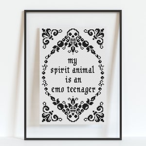 May include: Black and white cross-stitch embroidery framed in a black frame. The embroidery reads "my spirit animal is an emo teenager".