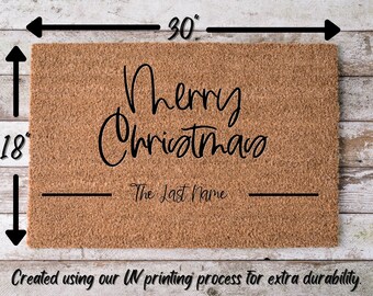 May include: A brown coir doormat with the text "Merry Christmas" and a blank line for a last name. The doormat measures 18 inches by 30 inches.