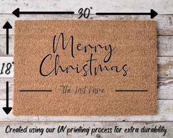 May include: A brown coir doormat with the text "Merry Christmas" and a blank line for a last name. The doormat measures 18 inches by 30 inches.
