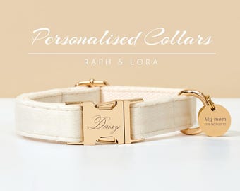 May include: Cream-colored personalized dog collar with gold-tone hardware. The buckle is engraved with the name "Daisy." A small, round tag reads "My mom" and a phone number. The text "Personalised Collars" and "Raph & Lora" are displayed above the collar.