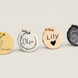 May include: Four personalised pet ID tags with different designs. The first tag is gold with a lily of the valley flower and the name Harrison. The second tag is silver with a wreath and the name Alfie. The third tag is rose gold with the name Lily and a small heart. The fourth tag is black with a castle and the name Baxter.