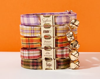 May include: Five colorful plaid dog collars with gold buckles and engraved names. The collars are stacked on top of each other. The names on the collars are Sylvia, Finn, Peter 5013886064, Lilo 28.08.2020, and Sofie.