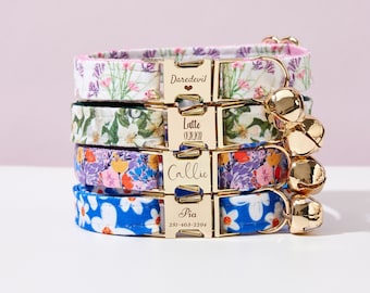 May include: Four colorful floral cat collars with gold buckles and bells. The collars are stacked on top of each other. The top collar has the name "Daredevil" engraved on the buckle. The second collar has the name "Latte" engraved on the buckle. The third collar has the name "Callie" engraved on the buckle. The bottom collar has the name "Pia" and a phone number engraved on the buckle.
