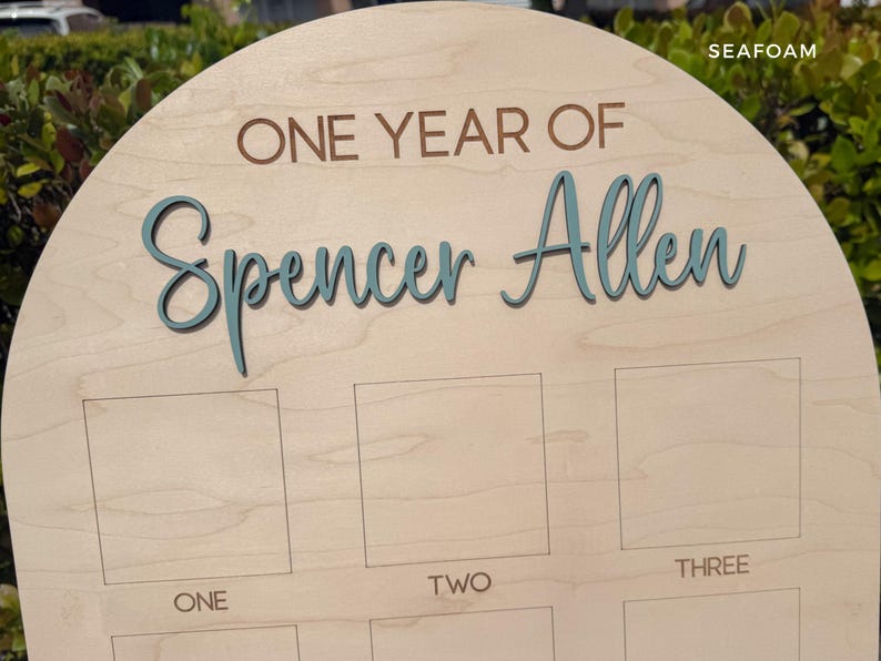Arch birthday photo board.  Showing the 3D name in a seafoam color.