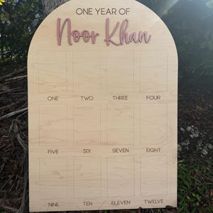 One Year Of photo board.  This birthdayphoto board is our large size.  Our Arch photo boards are peersonalized with a 3D name in a color of your choice.