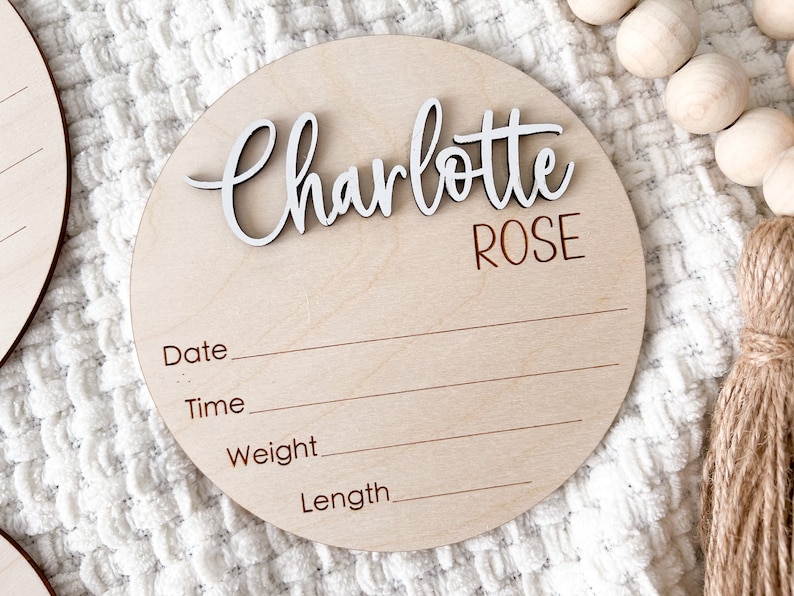 Wooden birth announcement sign with the name "Charlotte ROSE" in white #D first name and engraved middle name..