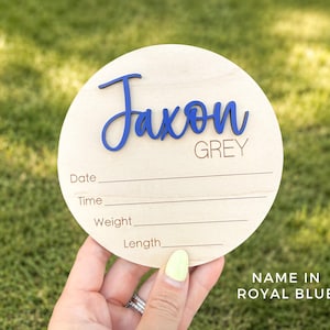 Personalized baby name announcement sign with custom name and birth details.