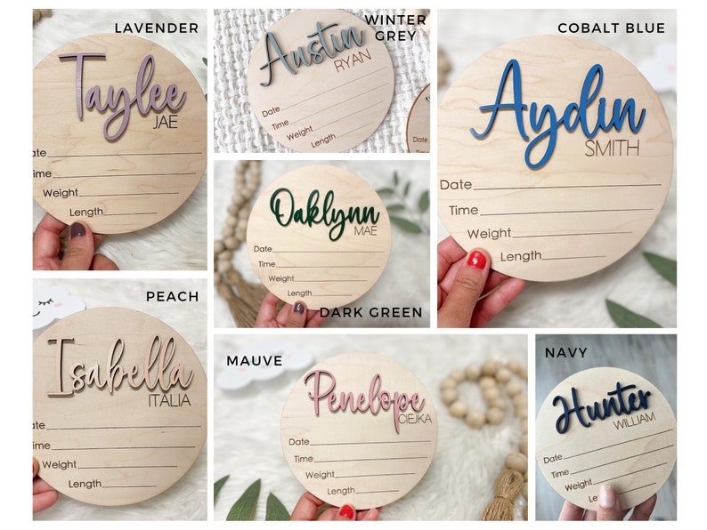 A collection of wooden baby announcement signs. Each round sign features the baby's name in a contrasting color, with space to record birth details.