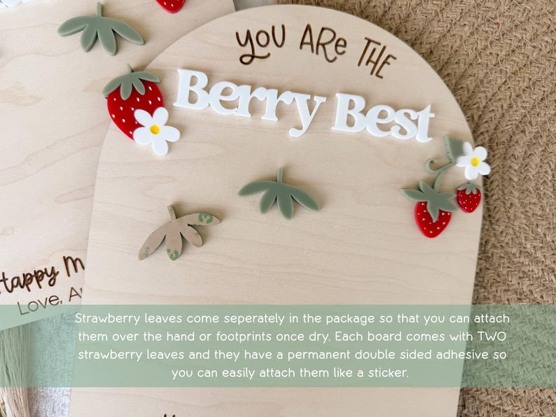 May include: Wooden plaque with the phrase "You Are The Berry Best" in white letters. The plaque is decorated with red strawberries, white flowers, and green leaves. A cute and cheerful design.