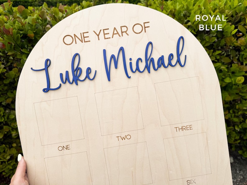 Large wooden birthday board.  Thee personalization is a 3D name done in royal blue.