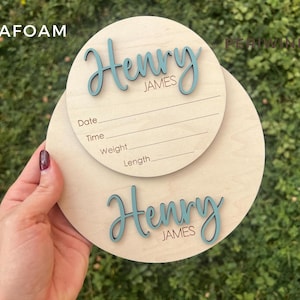 Wooden newborn birth announcement plaque with personalized baby name and birth stats.  Also showing 7" baby footprint wooden round.  Both baby announcement rounds are personalized with baby name.
