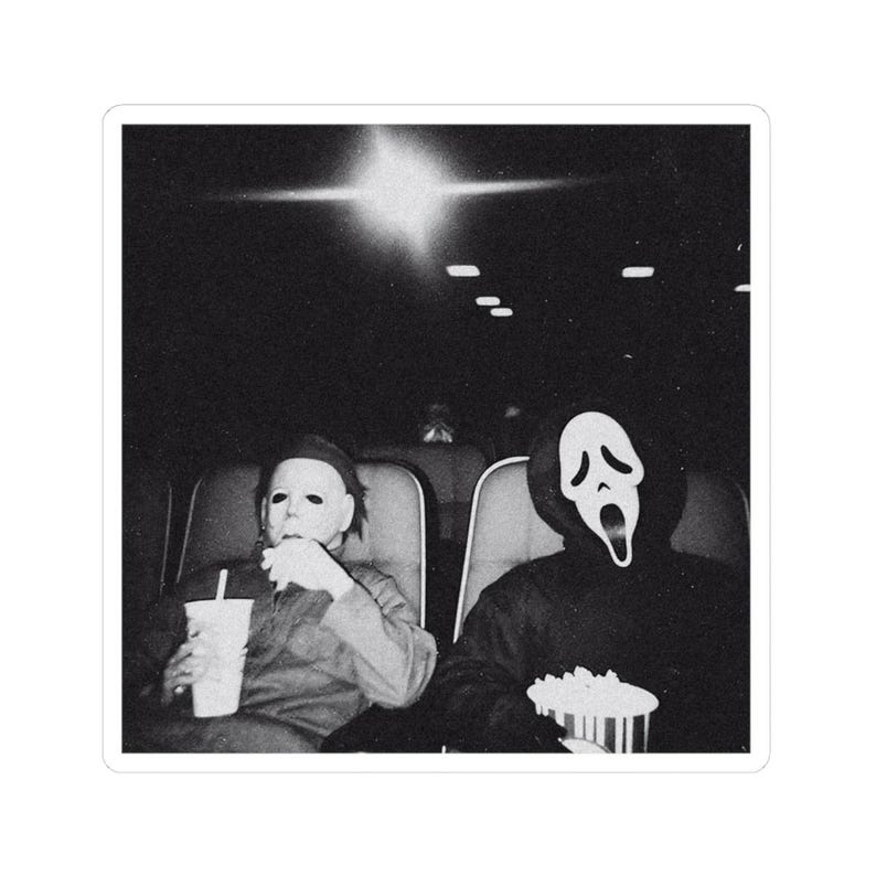 May include: Black and white sticker featuring two figures in a movie theater. One figure wears a Michael Myers mask and holds a drink. The other figure wears a Ghostface mask and holds popcorn. The background is dark.