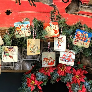 May include: A garland of vintage Christmas cards featuring Santa Claus, reindeer, and other holiday imagery. The cards are strung together with red and white twine and are hanging from a wooden mantelpiece.