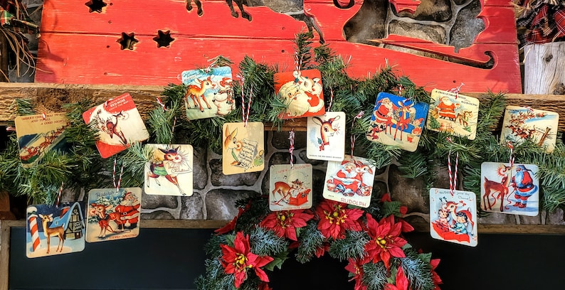 May include: A garland of vintage Christmas cards featuring Santa Claus, reindeer, and other holiday imagery. The cards are strung together with red and white twine and are hanging from a wooden mantelpiece.
