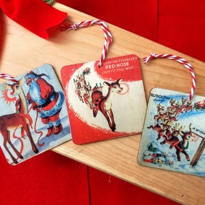 May include: Three vintage Christmas ornaments featuring Rudolph the Red-Nosed Reindeer. The first ornament shows Rudolph with Santa Claus, the second ornament shows Rudolph with the text "Rudolph the Red-Nosed Reindeer Lights the Way...", and the third ornament shows Rudolph with the text "Rudolph's Friends".