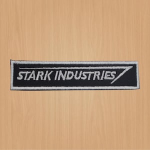 May include: A black embroidered patch with white stitching that reads "STARK INDUSTRIES".