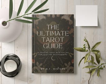 May include: A book titled "The Ultimate Tarot Guide" with a dark green cover featuring a detailed illustration of birds, flowers, and snakes. The text on the cover reads "To reading tarot with feeling for love and relationships" and "By M.F. Winters".