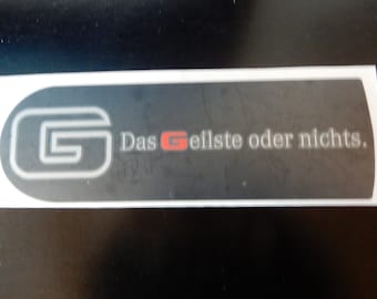 May include: A black and white sticker with a stylised letter G in a circle. The text "Das Gellste oder nichts." is printed below the G.