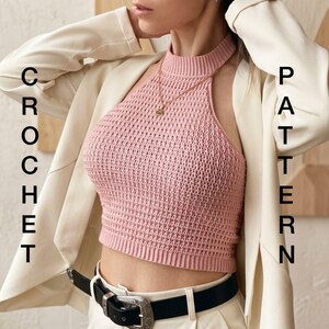 May include: A light pink sleeveless crochet crop top with a high neckline, worn under a cream-colored blazer with a black belt. The text CROCHET PATTERN is visible on the sides of the image. The top features a textured, woven stitch pattern.