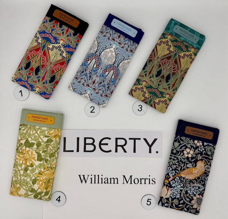 May include: Five fabric eyeglass cases with colorful floral and Art Nouveau patterns. Each case has a rectangular shape with a dark-colored top flap labeled "HANDMADE". The cases are numbered 1 through 5.