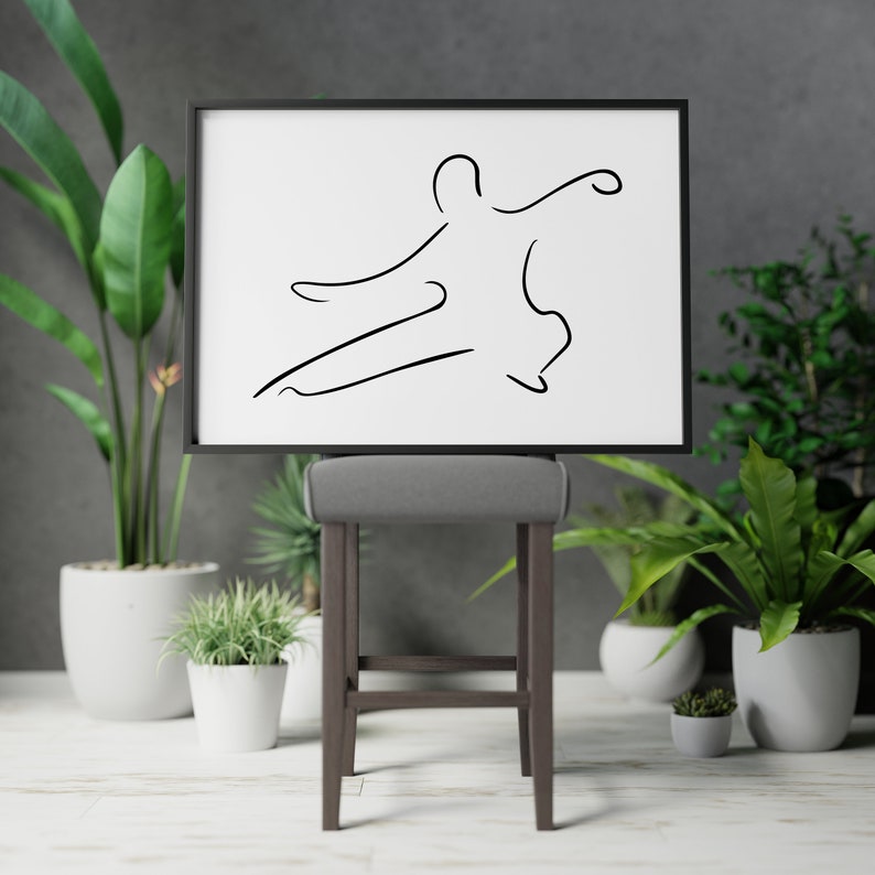 May include: A black framed print of a line drawing of a person in a martial arts pose, hanging above a gray bar stool.