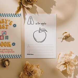 May include: A printable worksheet for learning the letter A. The worksheet features a black and white illustration of an apple with the text "A is for apple". There are lines for tracing the letter A and writing the word "apple".