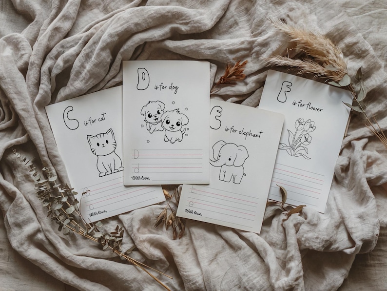 May include: Four black and white printable alphabet flashcards with illustrations of a cat, dog, elephant, and flower. Each card has a letter, the word for the image, and lines for writing.