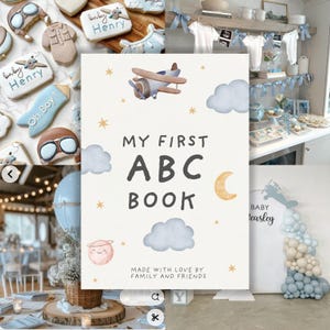 May include: A baby shower scene with a focus on a book titled "MY FIRST ABC BOOK". The book features an airplane illustration, clouds, and a crescent moon. The text "MADE WITH LOVE BY FAMILY AND FRIENDS" is also visible. Decorated cookies and balloons are also present.