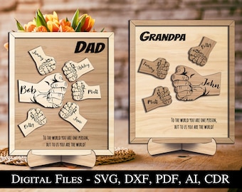 May include: Two wooden signs with the words "DAD" and "GRANDPA" on them. Each sign has a design of hands with names written on them. The text on the signs reads "To the world you are one person, but to us you are the world!"
