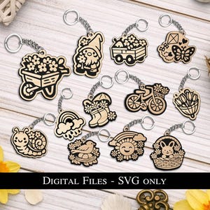 May include: A collection of wooden keychains with various spring-themed designs, including a wheelbarrow, gnome, wagon, butterfly, snail, rainbow, boots, bicycle, tulips, bird, sun, and bunny. Each keychain is attached to a silver chain. The text "DIGITAL FILES - SVG ONLY" is at the bottom.