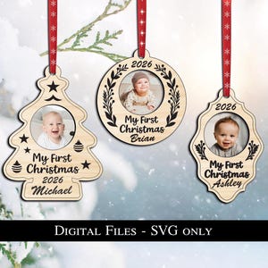 Pode incluir: Três enfeites de Natal de madeira com fotos de bebês. Cada enfeite tem uma fita vermelha para pendurar e o ano de 2026. Os enfeites têm a forma de uma árvore de Natal, um círculo e uma forma decorativa, com o texto "My First Christmas" e um nome.