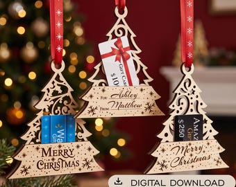 May include: Three laser-cut wooden Christmas tree ornaments with red ribbon hangers. Each ornament features a slot for a gift card and engraved text including Merry Christmas, For: Ashley From: Matthew, and various snowflake patterns.