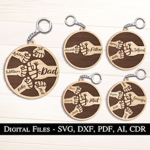 May include: Five wooden keychains with a fist bump design. Each keychain has a different name and title, such as "Dad", "Father", "Grandpa", and "Setpad".