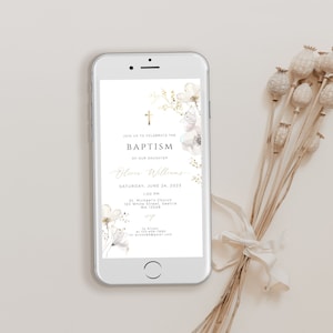 May include: A mobile phone shows a baptism invitation with floral details. The invitation text includes "BAPTISM" and "Olivia Williams", with the date June 24, 2023. Dried flowers with a white ribbon are in the background.