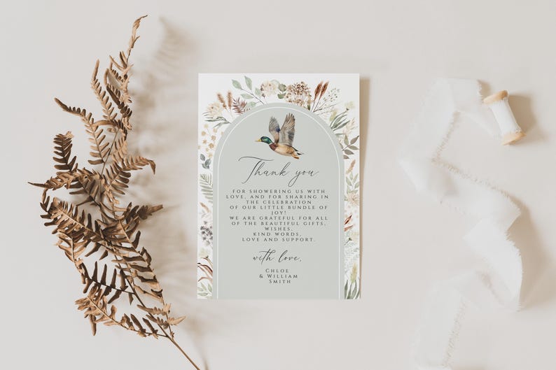May include: A light blue thank you card with a watercolor illustration of a duck flying through an archway of greenery. The text reads "Thank you for showering us with love and for sharing in the celebration of our little bundle of joy. We are grateful for all of the beautiful gifts, kind words, love and support. With love, Chloe & William Smith."