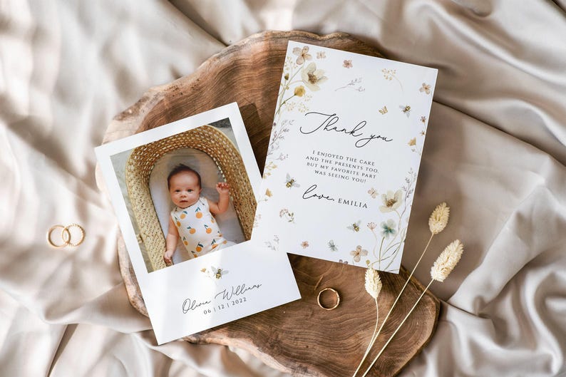 May include: A thank you card with a floral design and the text "Thank you I enjoyed the cake and the presents too but my favorite part was seeing you! Love, Emilia". A photo of a baby in a basket is included on a separate card with the text "Olou Williams 04.11.22.2022".