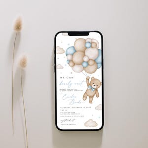 May include: A digital invitation for a baby shower featuring a teddy bear holding onto blue and beige balloons. The text on the invitation reads "We can barely wait!" and "Emily Brooks".