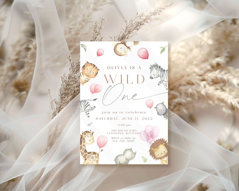 May include: A white invitation card with a pink and brown watercolor illustration of animals. The text on the card reads "Olivia is a Wild One" and includes details for a birthday party.